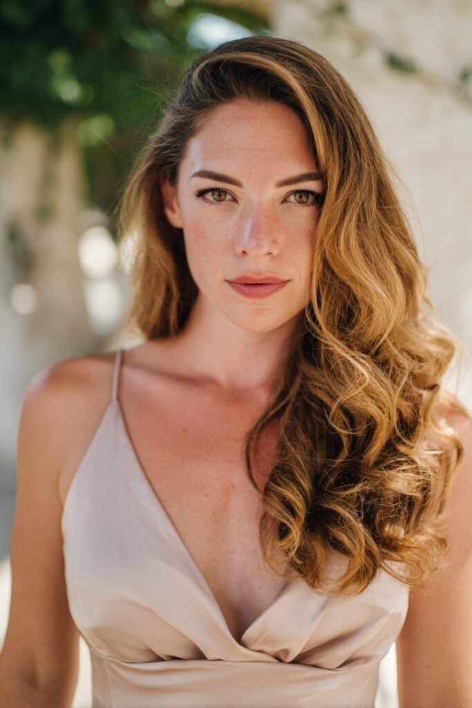 bridesmaid with side swept curls and cascading volume