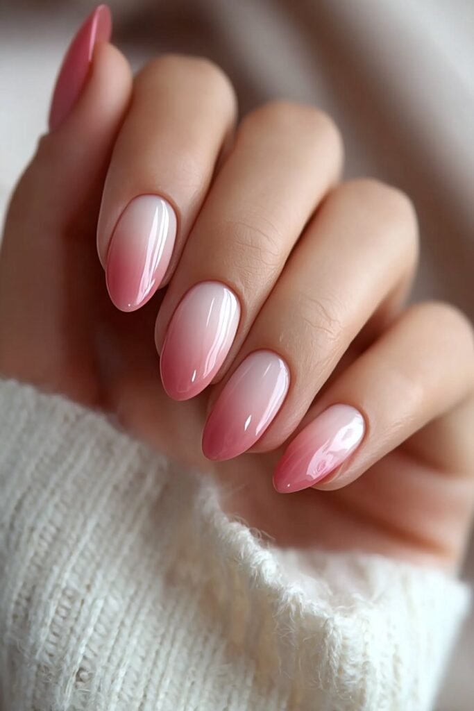 Blush pink ombre nails fading into soft white tips.