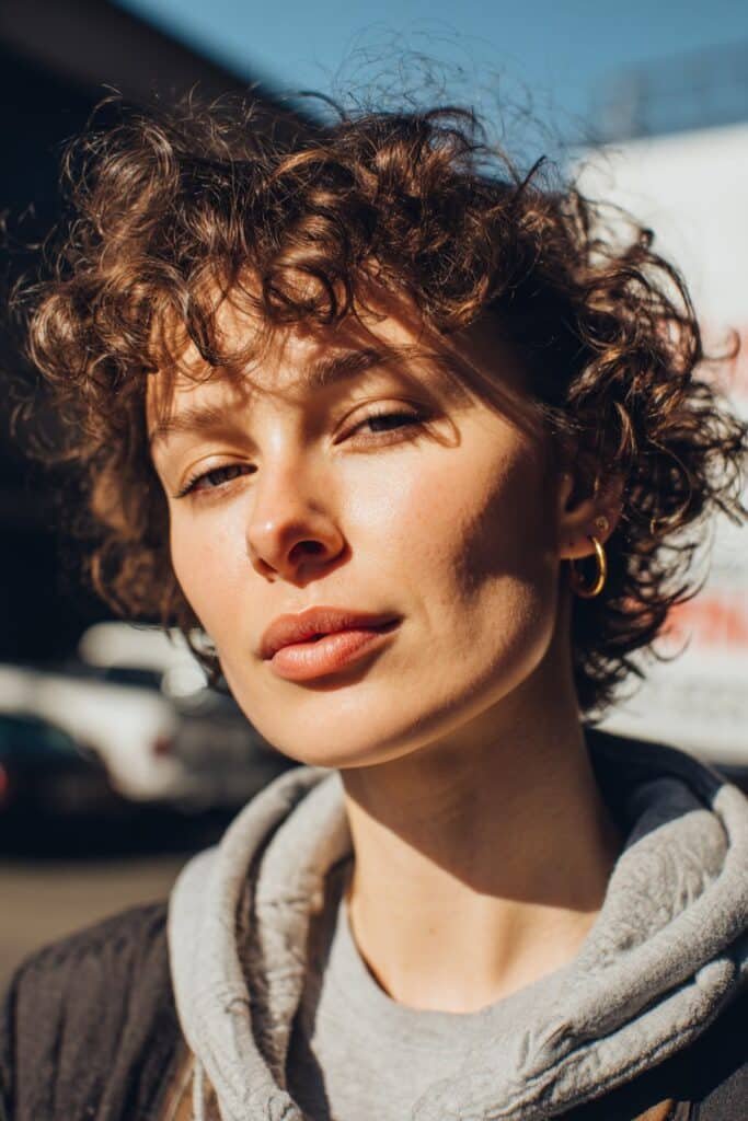 soft fade with natural curls on top, short curly hairstyle detail