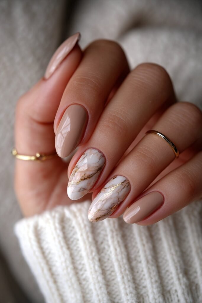 Nails with marble swirls and subtle gold veins.