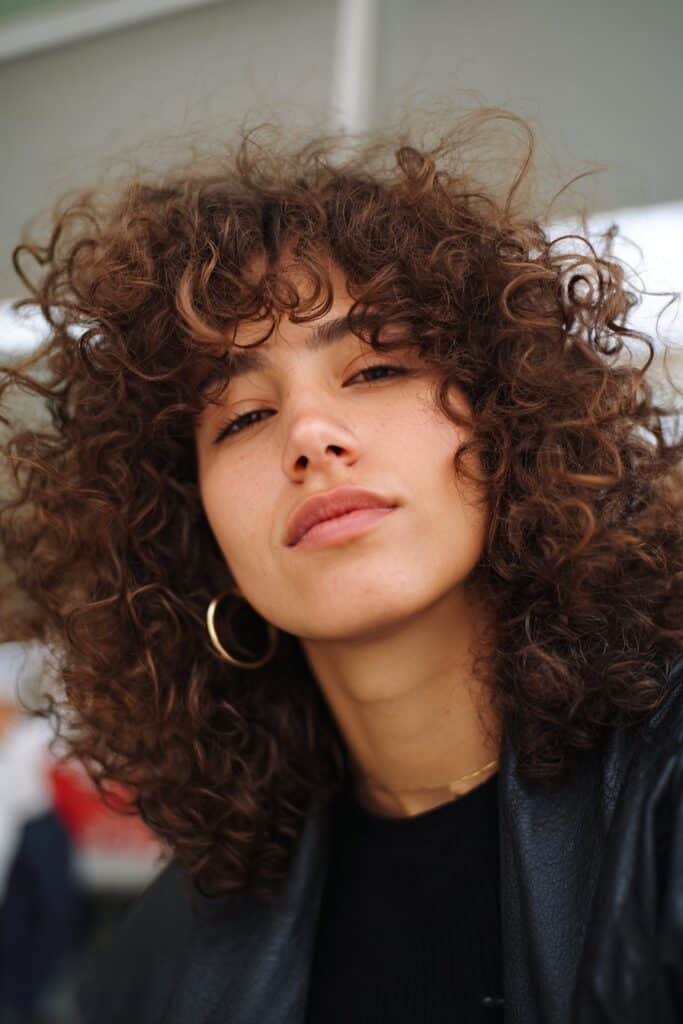 woman with big bouncy curls hairstyle