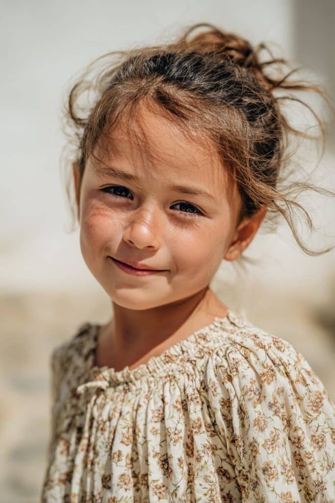 flower girl with boho loose bun hairstyle