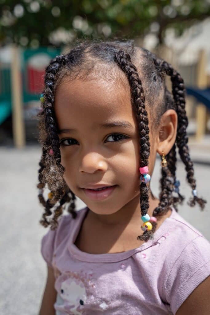 girl with box braids hairstyle, neat braids with beads
