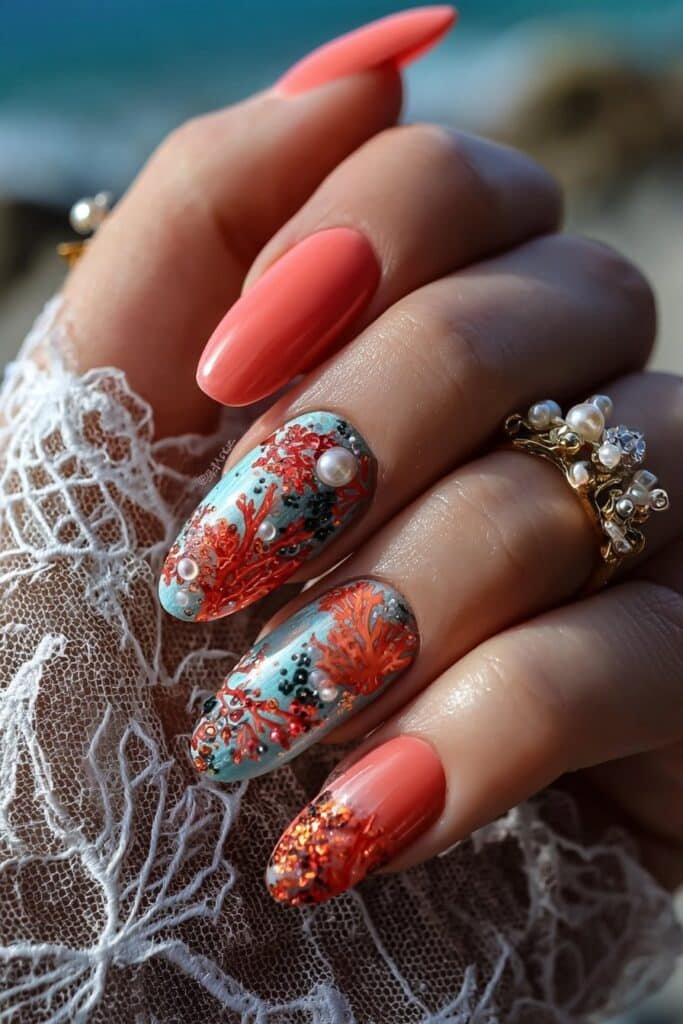 Coral reef inspired nails with turquoise and pearl accents.