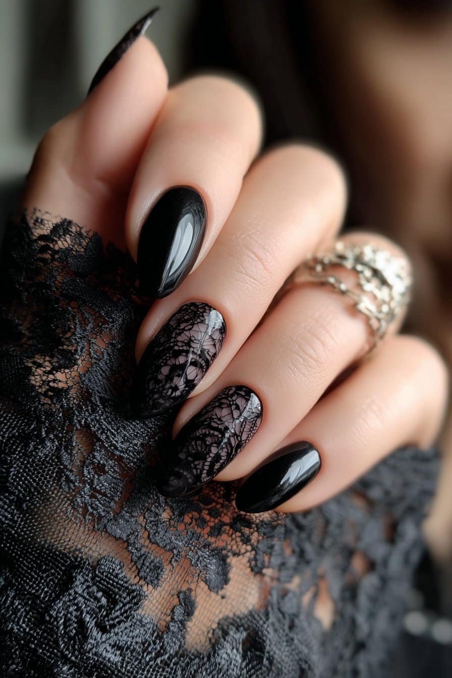 Sheer black nails with intricate floral lace detailing.