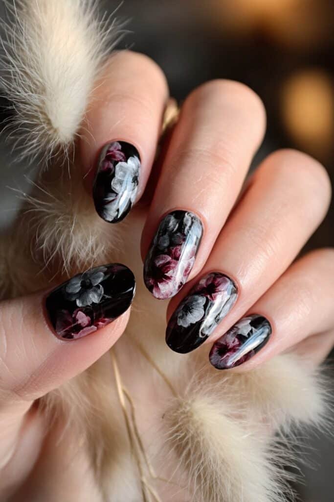 Dark nails with watercolor floral blooms in deep shades.