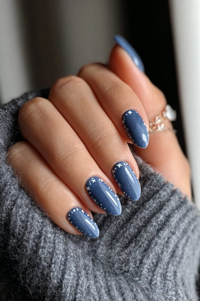 Denim inspired blue nails with tiny white star accents.