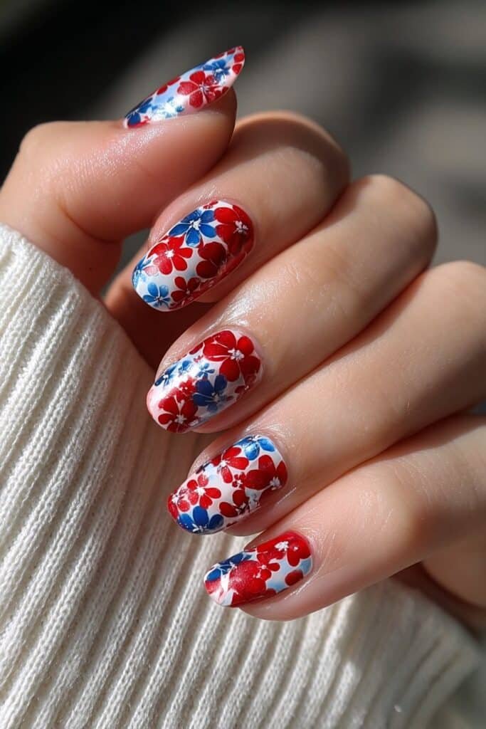 Patriotic nails with red, white, and blue floral patterns.