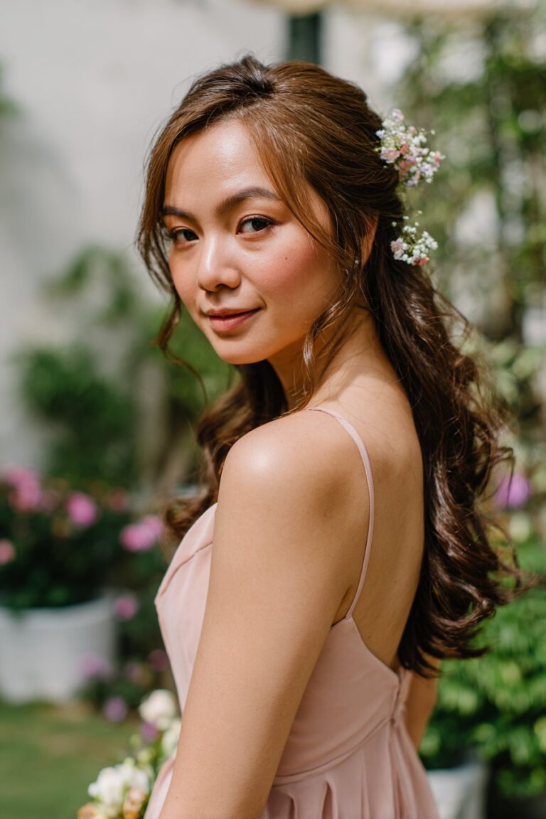 bridesmaid with floral pinned half up hairstyle