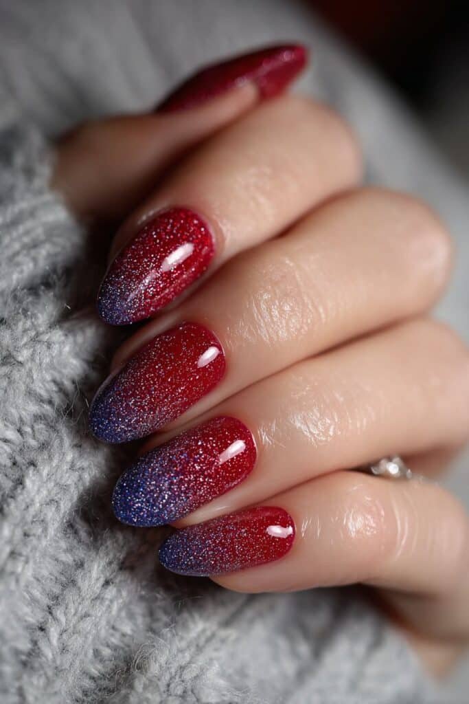 Red and blue glitter gradient nails with glossy finish.