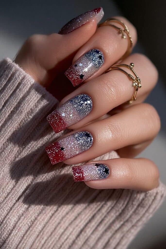 Patriotic nails with glitter stars and striped accents.