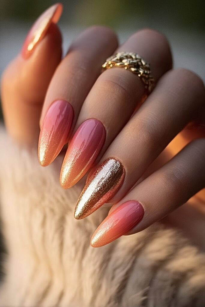 Sunset ombre nails in gold, coral, and peach tones.