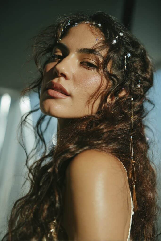 woman with loose curls and patriotic gem hair accents