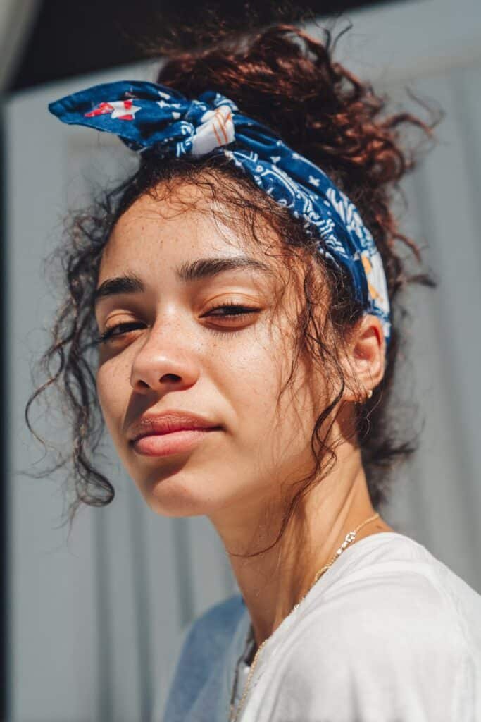 woman with messy bun and patriotic bandana hairstyle