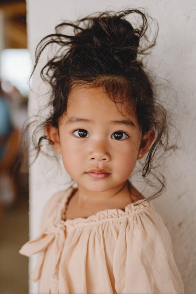 flower girl with messy chignon bun hairstyle