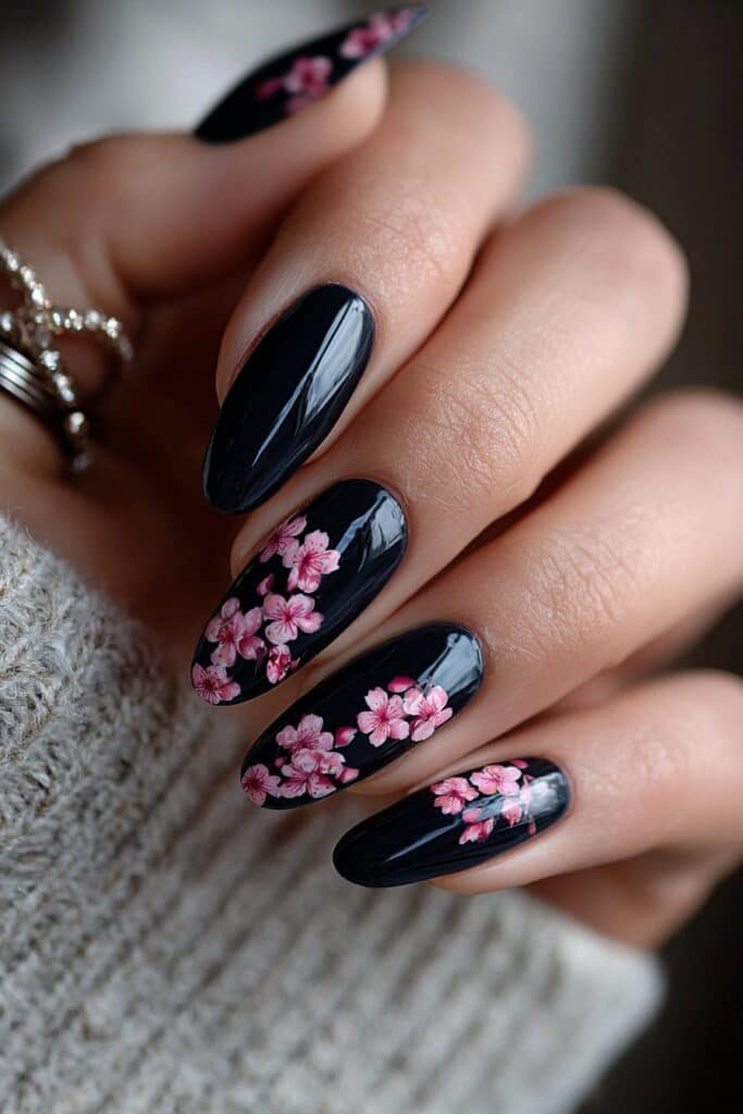 Midnight blue nails with soft pink cherry blossom flowers.