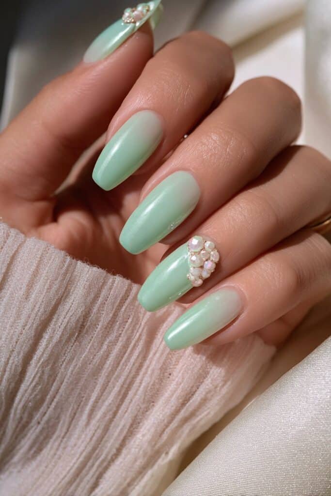 Mint green nails with subtle white accent details.
