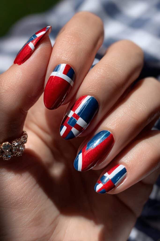 Red, white, and blue geometric nails with negative space details.