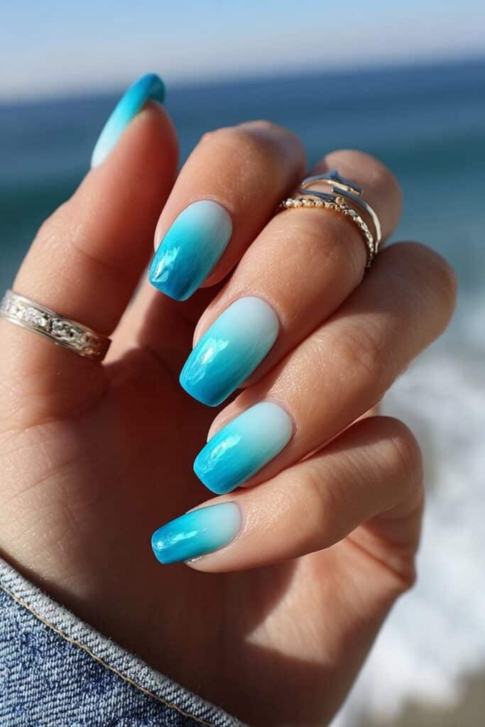 Ocean blue ombre square nails with soft white gradient tips.
