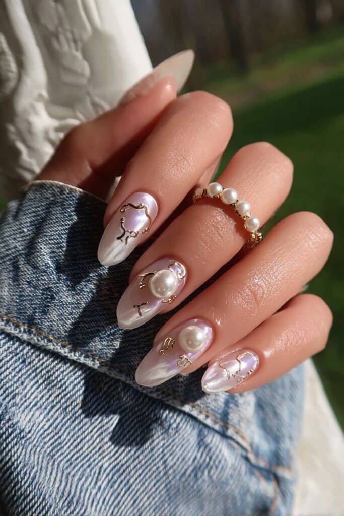 Pearl-inspired nails with elegant Gemini zodiac details.