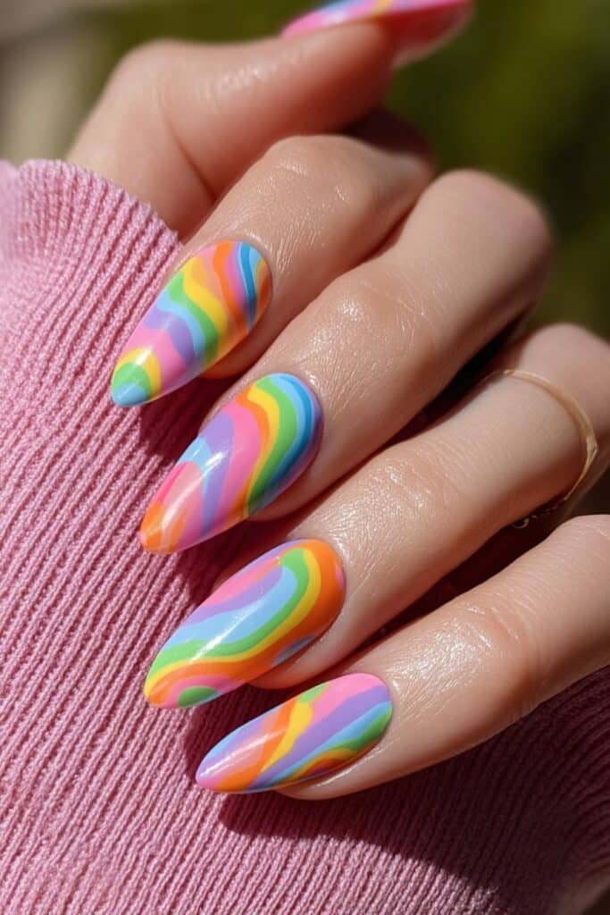 Colorful rainbow swirl nails in playful pastel shades.