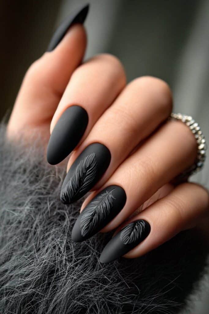 Matte black nails with subtle raven feather details.
