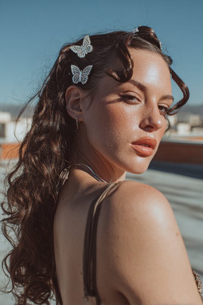 woman with side-swept curls and sparkling butterfly clips