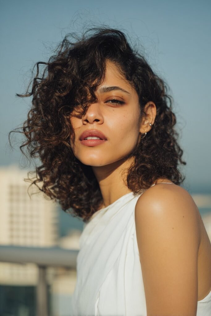 woman with side swept curly hairstyle