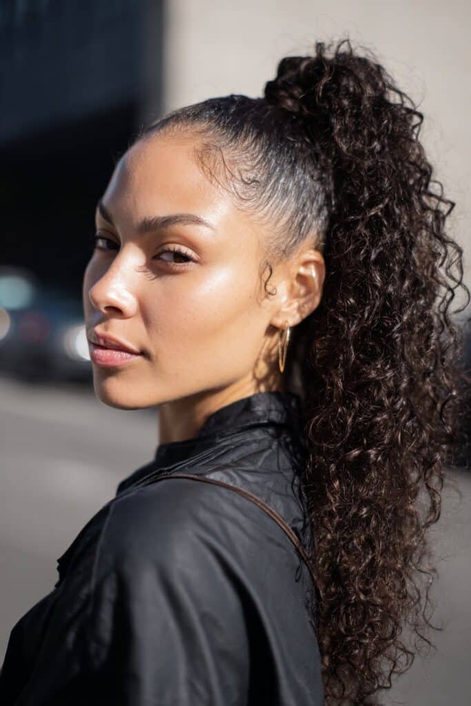woman with sleek curly ponytail, high defined curls
