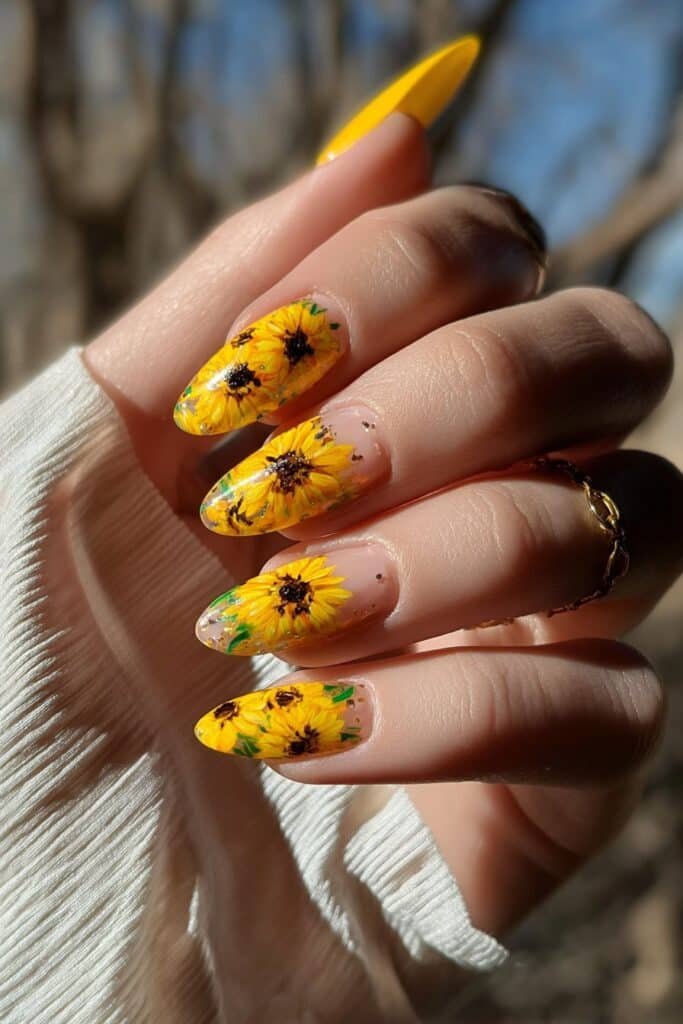 Sunflower nails with bright yellow petals and green accents.