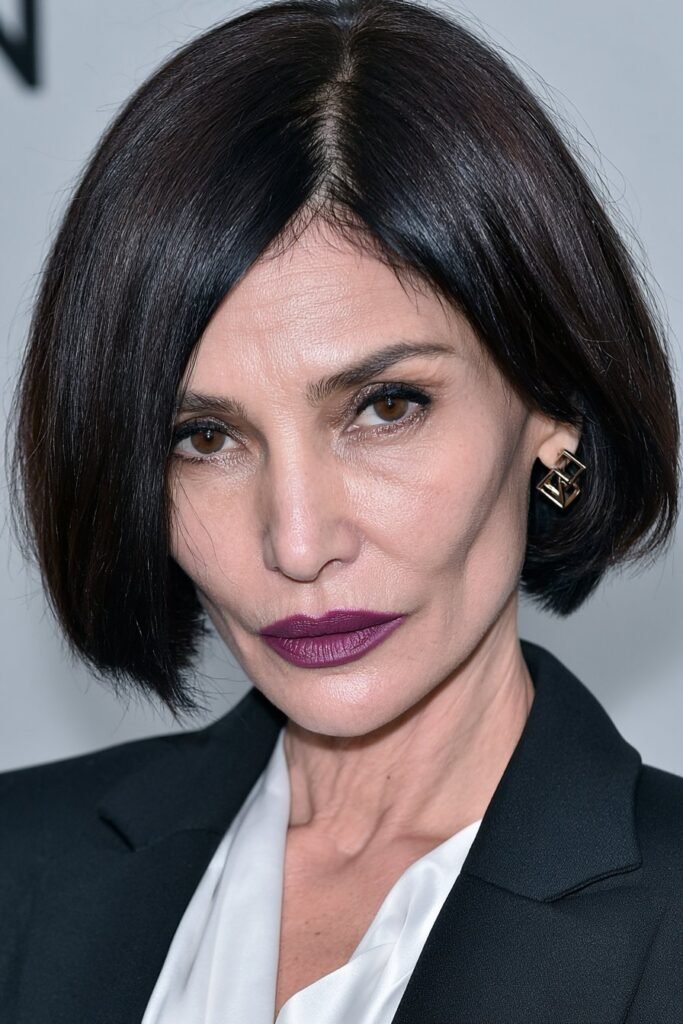 Chic mature woman with a sleek espresso brown French bob and polished editorial styling.