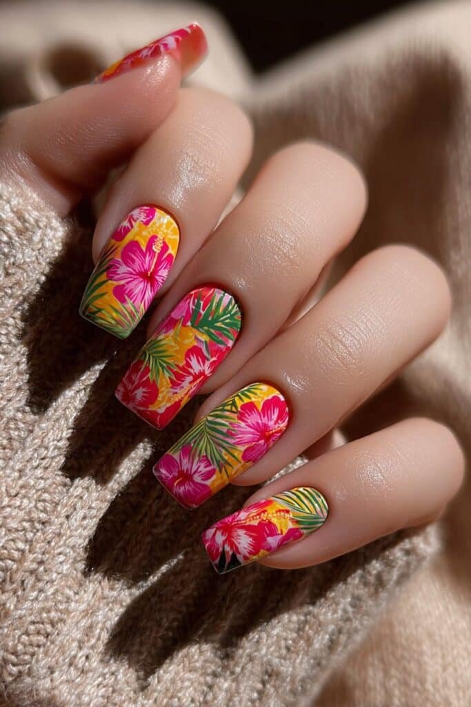 Square nails with vibrant tropical flowers and palm leaf accents.