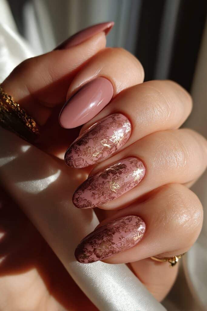Dusty rose Taurus nails with antique floral patterns and gold accents.