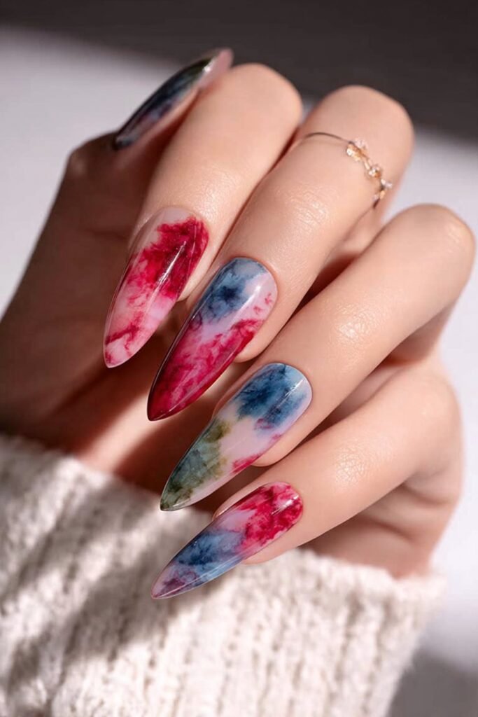 Red, white, and blue watercolor nails with soft blended effects.