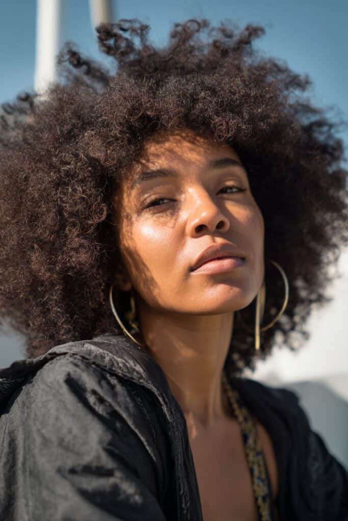 woman with afro curls, voluminous natural hairstyle