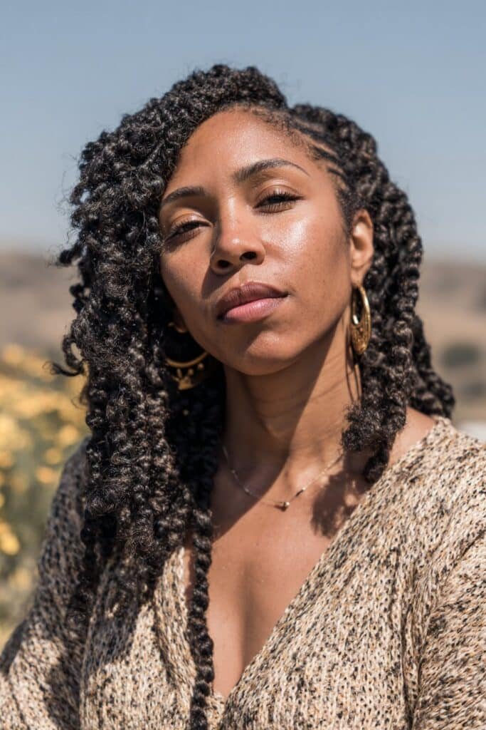 Black woman with bohemian kinky twists and loose curly ends.