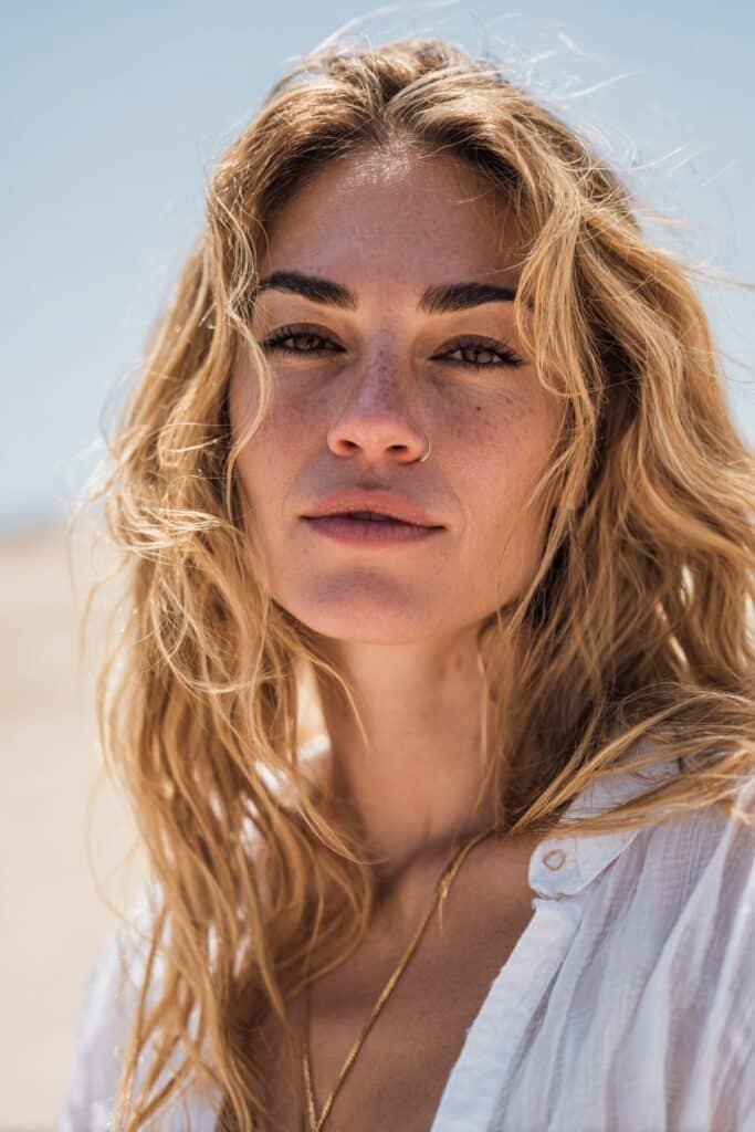 Woman with shoulder-length classic tousled beach waves and soft natural texture.