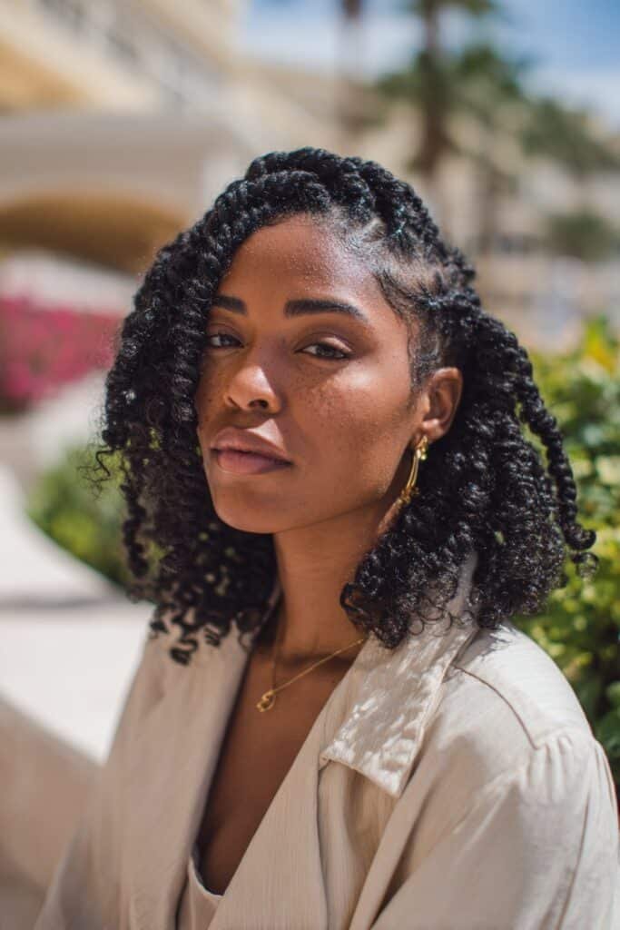 Black woman with kinky twist braids and soft curly ends.