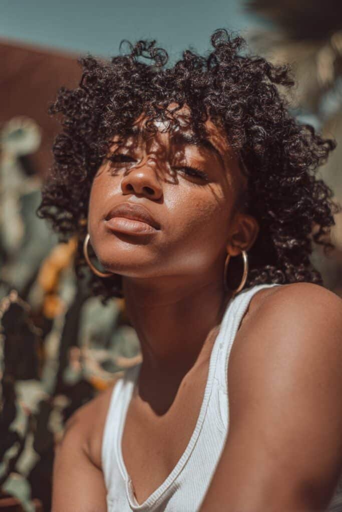 Black woman with passion twist inspired kinky twists and soft textured volume.