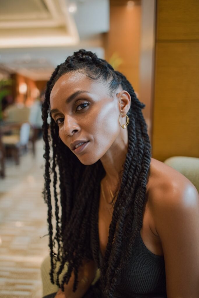 Black woman with Senegalese-inspired kinky twists and sleek protective styling.