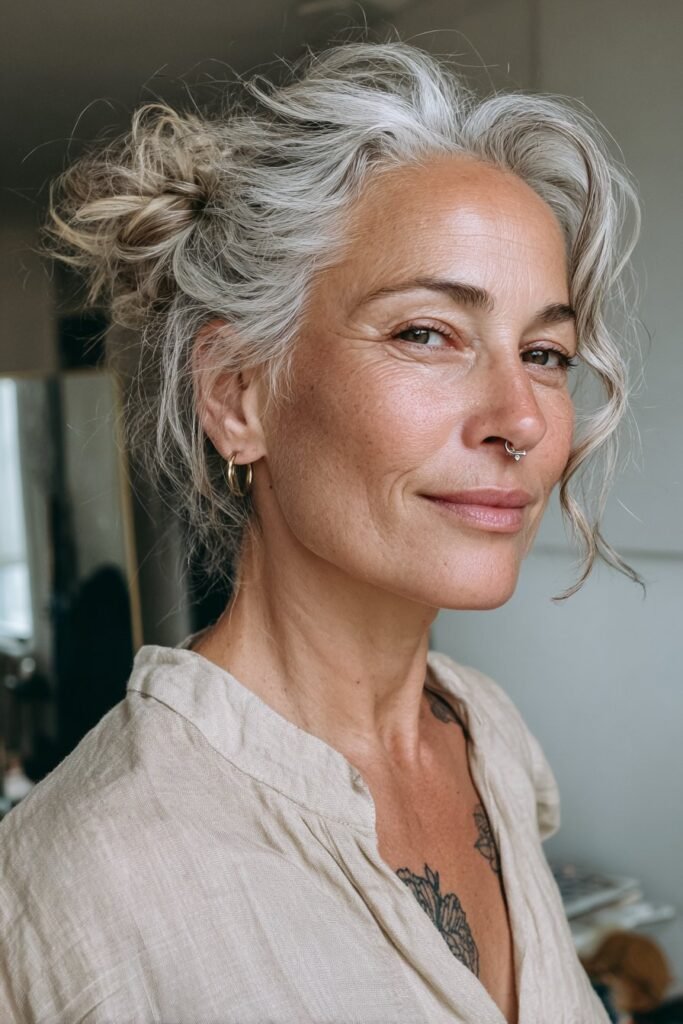 Chic updo with loose tendrils for women over 50.