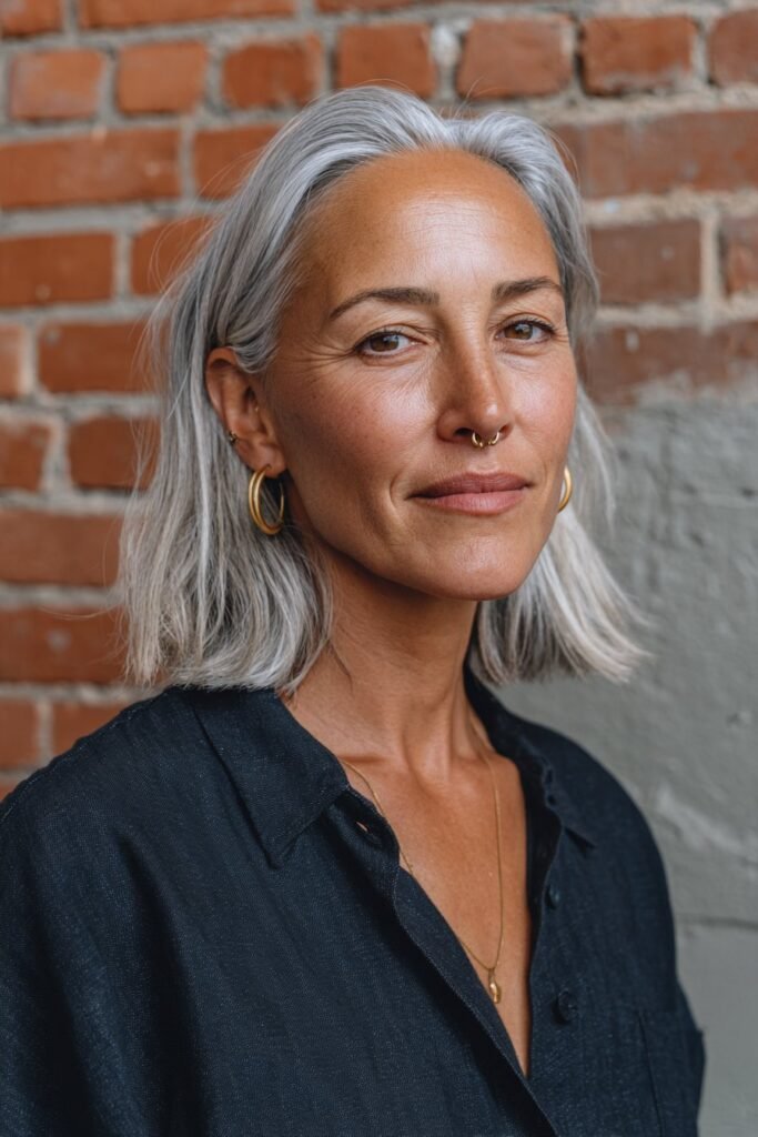 Sleek silver lob hairstyle for women over 50.