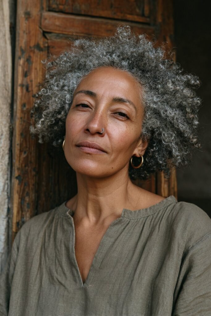 Voluminous afro with natural coils for older women.