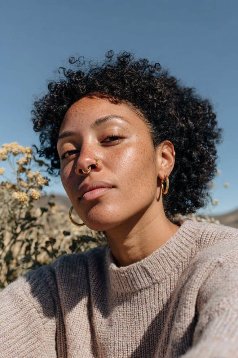 Black woman with an afro puff and laid edges.