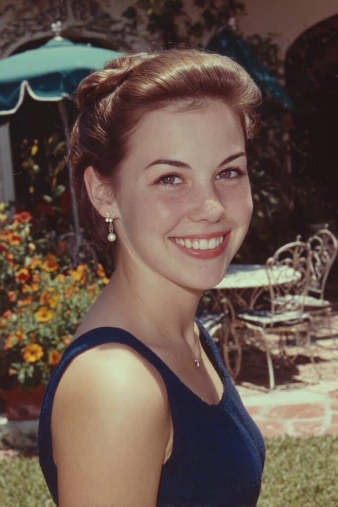 Woman with a French twist featuring a classic updo and soft face-framing curls