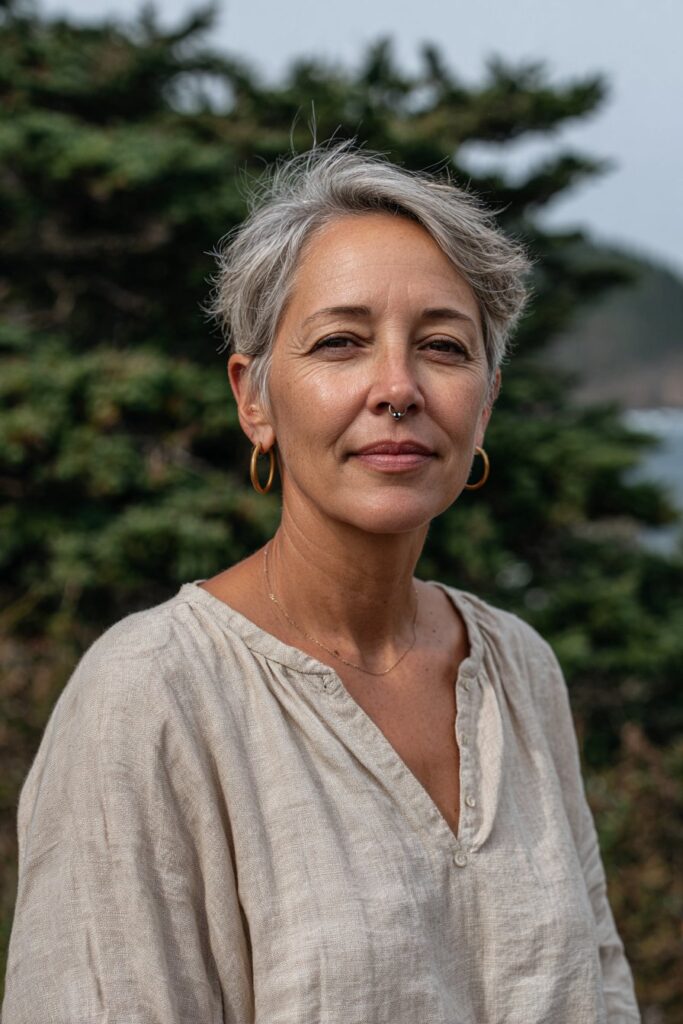 Smiling woman over 50 with a short gray pixie cut and textured layers