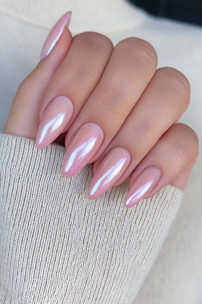 Short almond nails in translucent creamy nude with a soft white glazed chrome finish.
