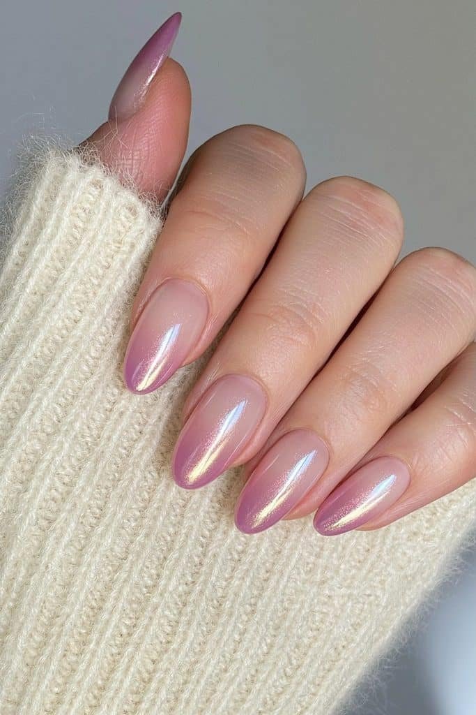Short almond nails with luminous aura centers and a translucent glazed chrome finish.