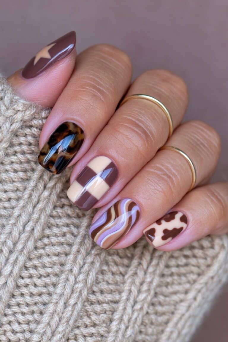 Nails featuring a mix-and-match autumn manicure with warm brown tones, abstract accents, and glossy finish.