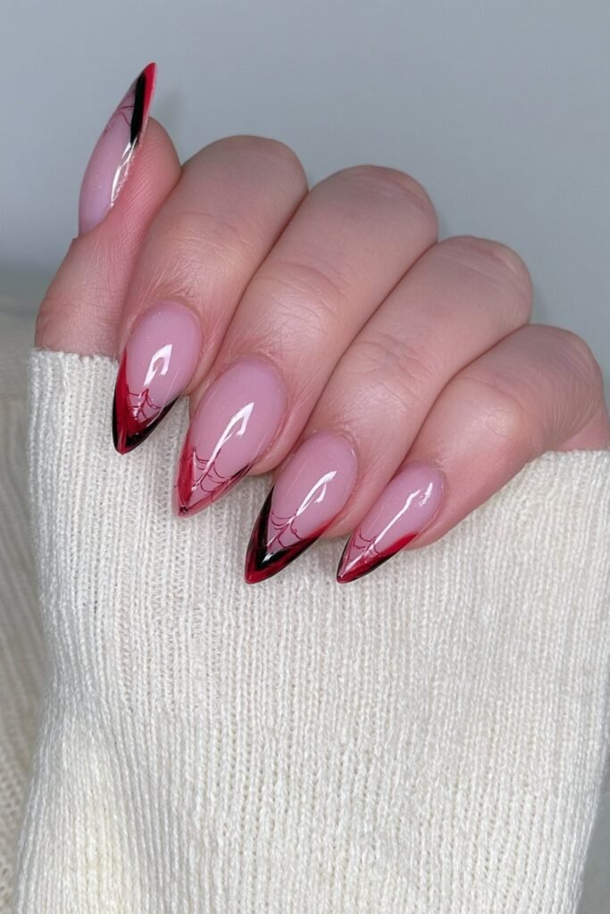 Black and red French tips with spider web accents.